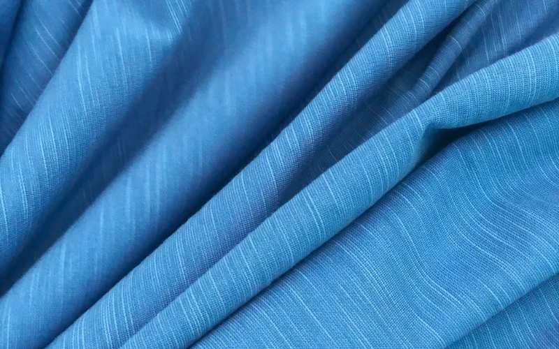Cotton is widely used in hot-weather clothing because it is soft, breathable, familiar, and comfortable against the skin.
